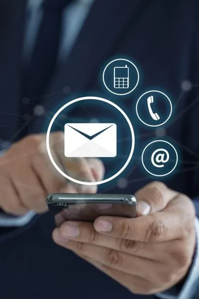 A close-up shot of a person in a business suit using a smartphone
