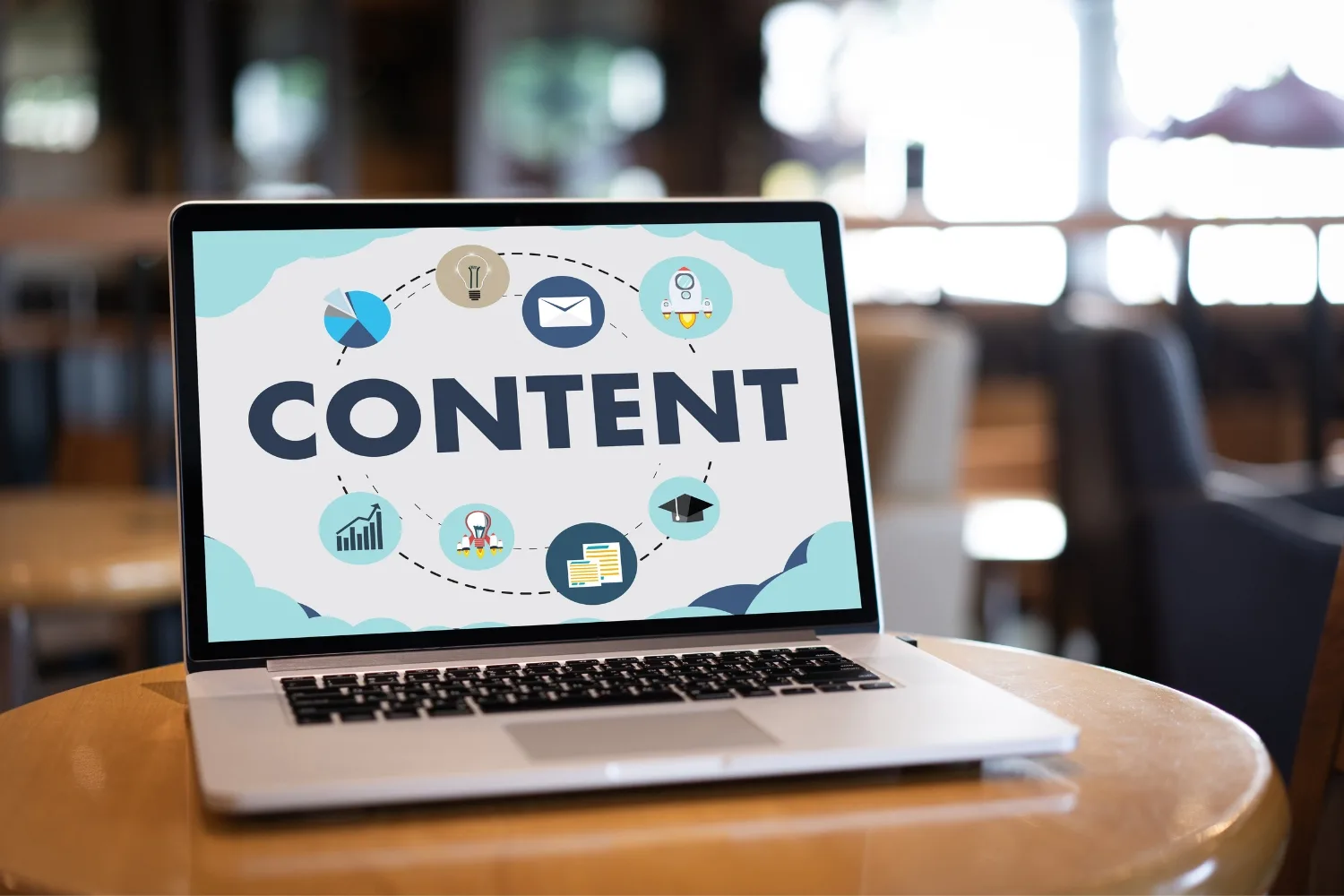 laptop on a table with the word content on the screen